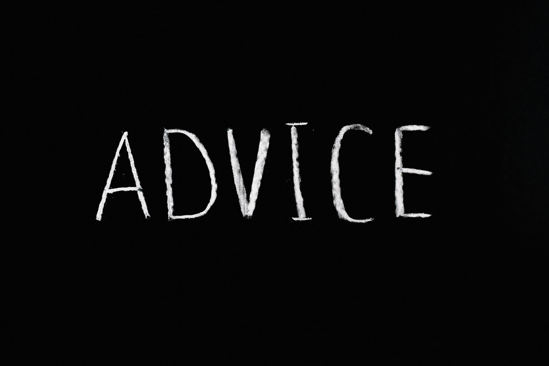 Word advice written on a black board