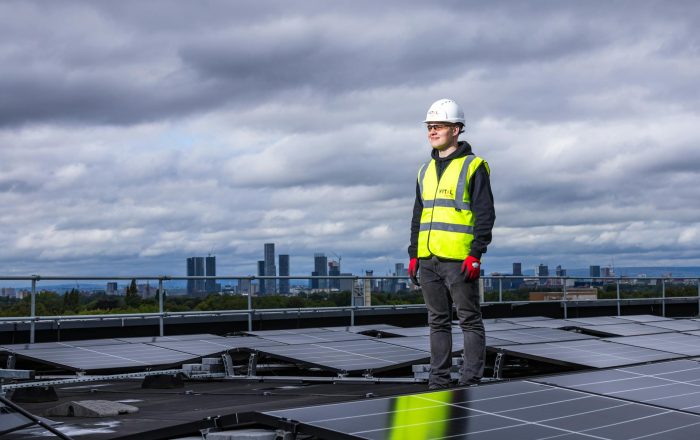 A man on the rooftop, solar panels